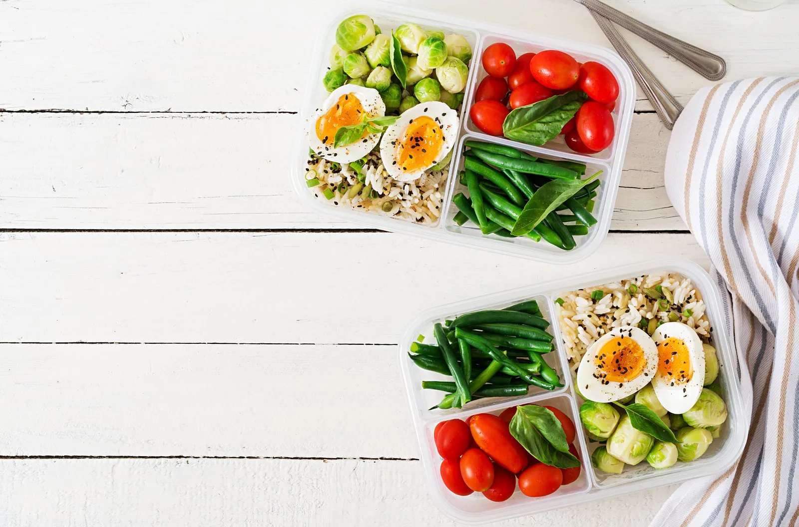 Meal prep containers with eggs, vegetables and lean protein portions