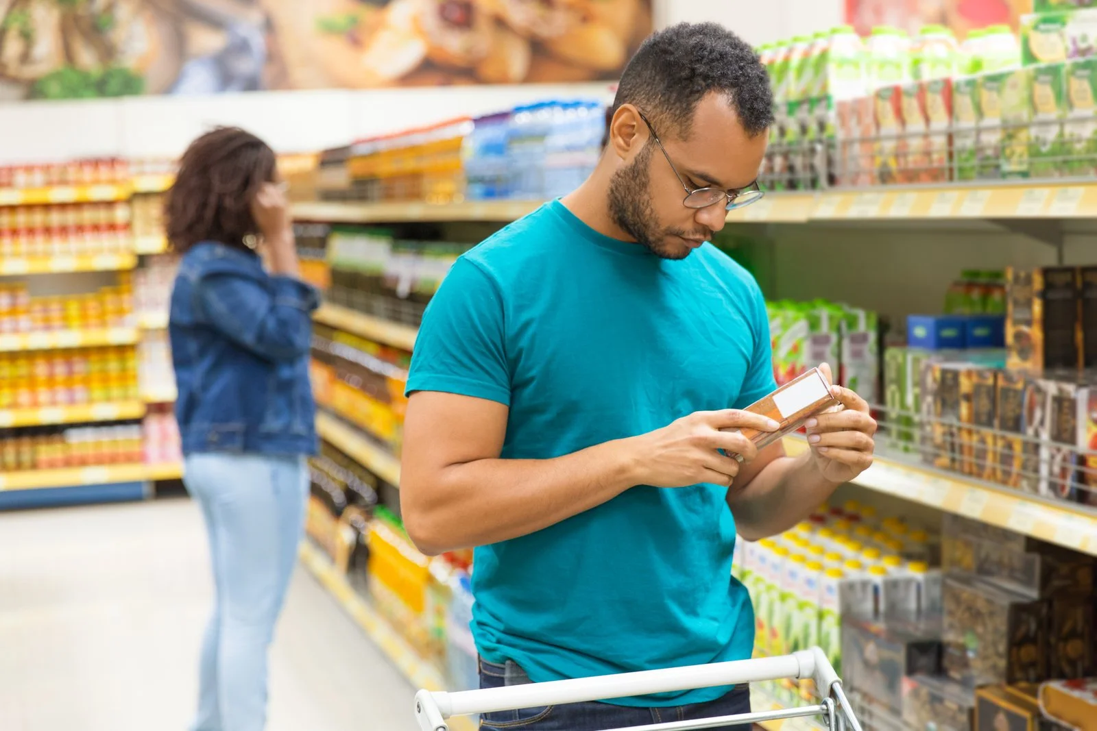 A man reading the ingredients information on a food packet
